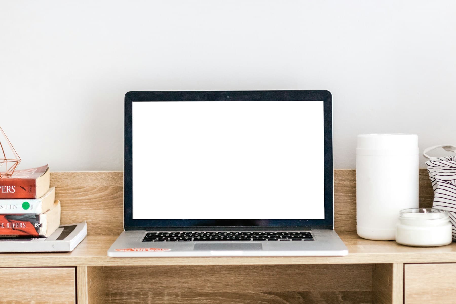 Laptop mockup with a bright empty screen on a wooden desk